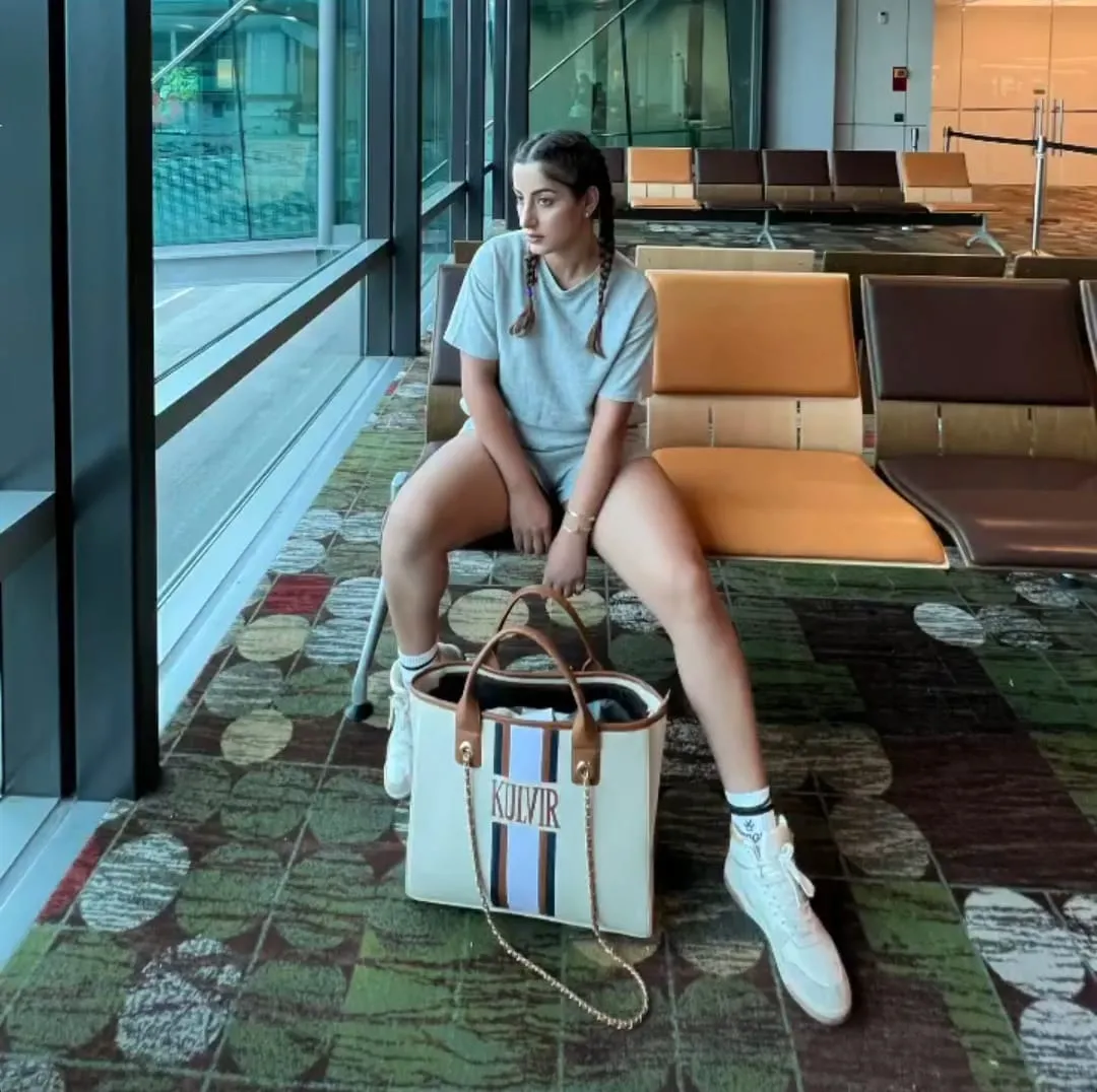 Off white bag with navy blue, brown and white stripes
