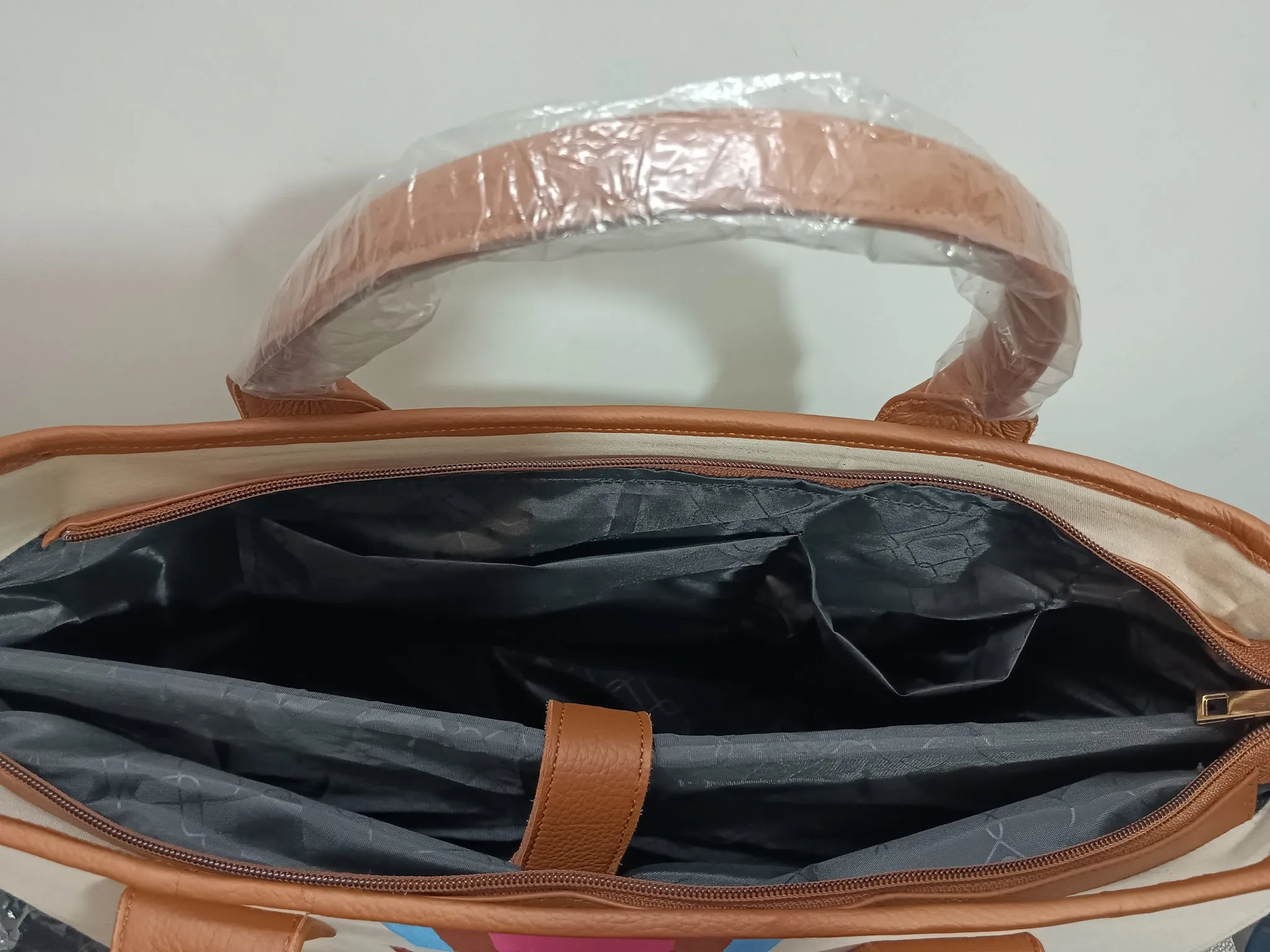 Off white bag with navy blue, brown and white stripes
