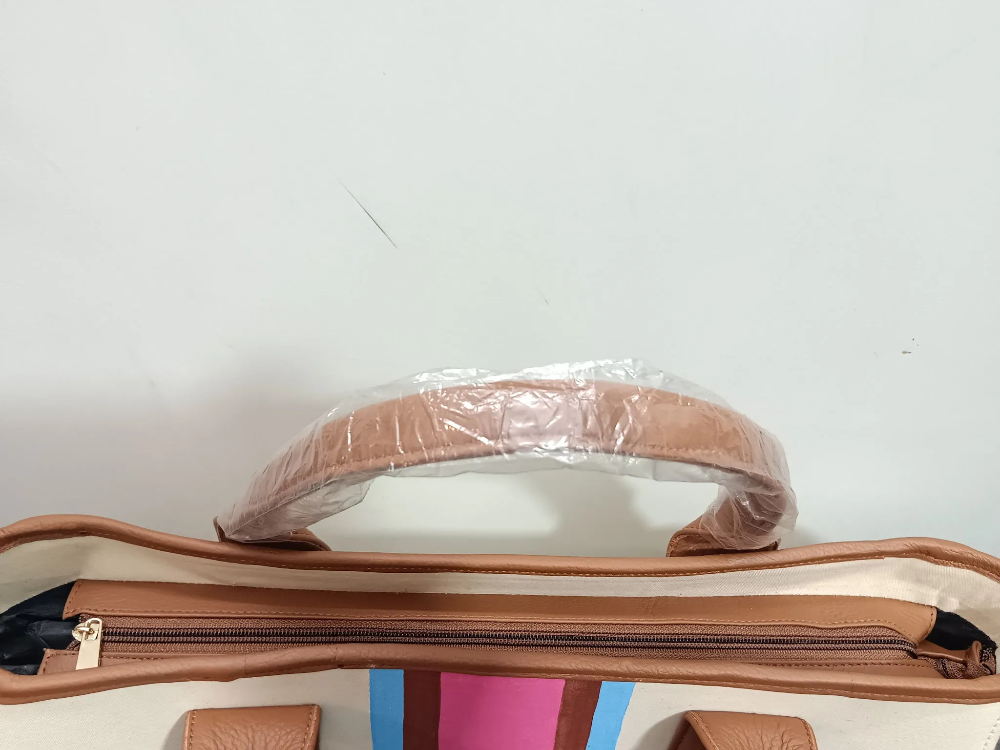 Off white bag with navy blue, brown and white stripes